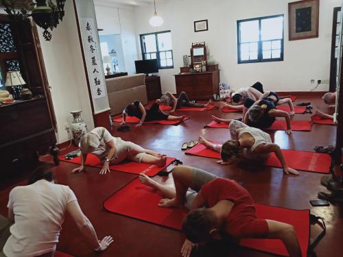 a group of people doing yoga in a room at Kaya Residence Kandy in Kandy