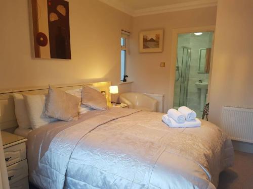 a bedroom with a bed with two towels on it at Balcony House in Galway