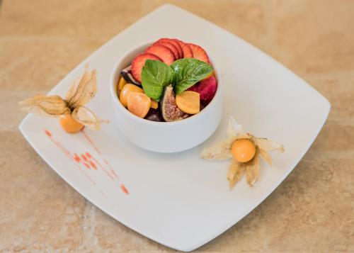 a bowl of fruit on a white plate at Hotel Los Tambos Boutique in Arequipa