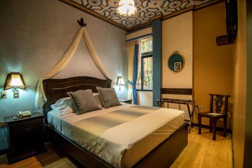 a bedroom with a large bed with a canopy at Morenica del Rosario in Cuenca