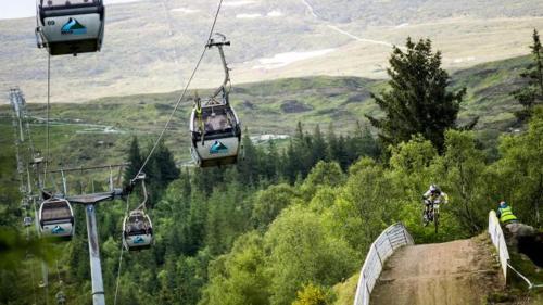 a group of gondolas flying over a mountain at Bank Street Lodge in Fort William