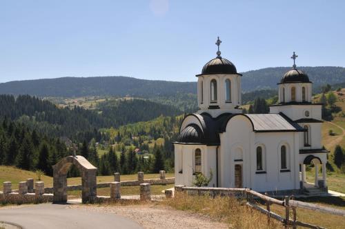 a church on the side of a hill at Vila Jelena Zlatar Nova varoš in Brdo