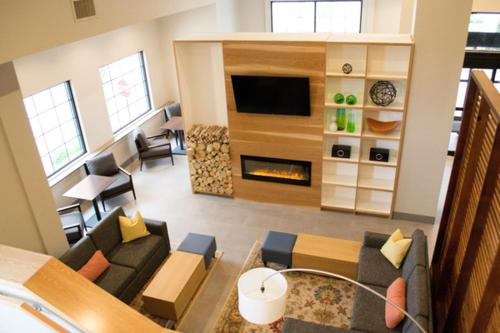 a living room with a couch and a fireplace at Country Inn & Suites by Radisson, Erie, PA in Erie