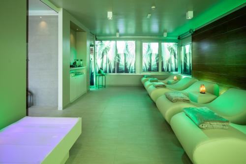 a living room with a long line of couches at Hotel Ascot & Spa in Rimini