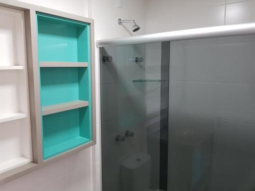 a bathroom with a shower with a glass door at Melhor Condomínio Villas no Campeche in Florianópolis
