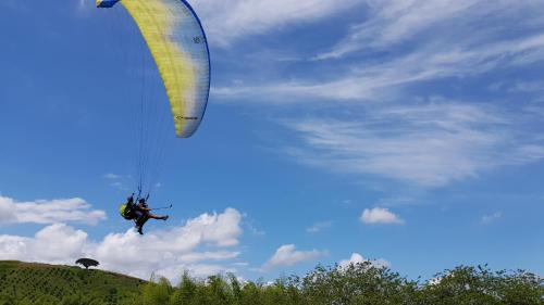 a person riding a paraglider in the sky at Beta Hotel in Salento