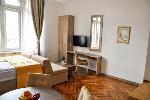 a hotel room with a bed and a tv at MAROON Free Parking in Sarajevo