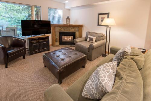 a living room with a couch and a fireplace at Valhalla Vacations at Whistler in Whistler