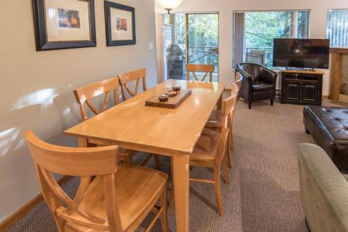 a living room with a wooden table and chairs at Valhalla Vacations at Whistler in Whistler