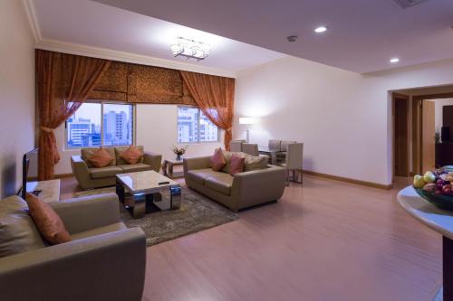 a large living room with couches and a table at Al Safir Tower - Residence in Juffair