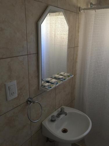 a bathroom with a sink and a mirror at Hotel Davinci in San Bernardo