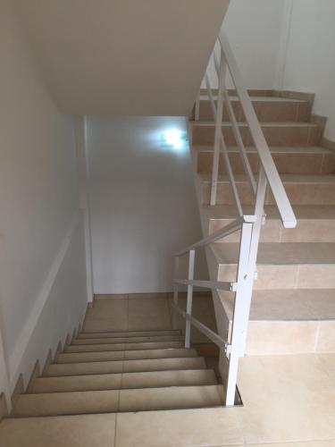 a staircase in a room with a white wall at Hotel Davinci in San Bernardo
