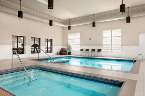 a large pool with blue water in a room at Microtel Inn & Suites by Wyndham Val-d Or in Val-dʼOr