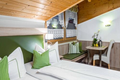 ein Schlafzimmer mit einem Bett und einem Tisch mit einem Tisch in der Unterkunft Gasthof Metzgerei Stöberl in Lam