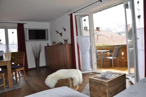 a living room with a large sliding glass door at Haus Erli in Mittenwald