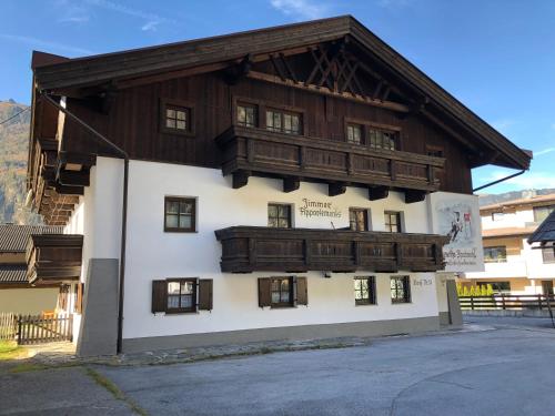 a large wooden building with a balcony on it at Aparts33 in Längenfeld
