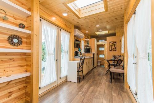 a living room with wooden walls and a skylight at Tiny House Leadville Colorado in Leadville