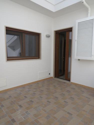 an empty room with a white wall and a window at Casa Rita in Manduria