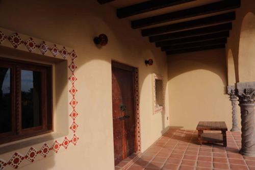 a hallway of a house with a wooden door at Nomada hotel in La Ventana