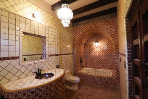 a bathroom with a sink and a tub and a toilet at Nomada hotel in La Ventana