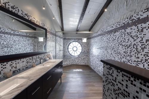 a bathroom with two sinks and a window in it at Secret Harbour Boutique Hotel and Marina in Lance aux Épines