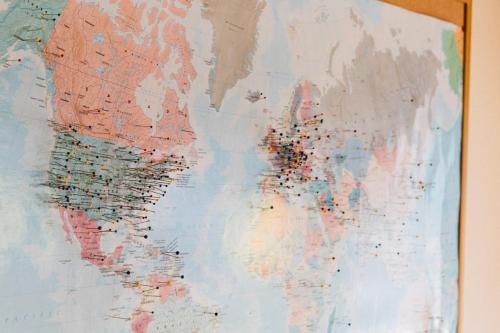 a map of the world hanging on a wall at The Hostel California in Bishop
