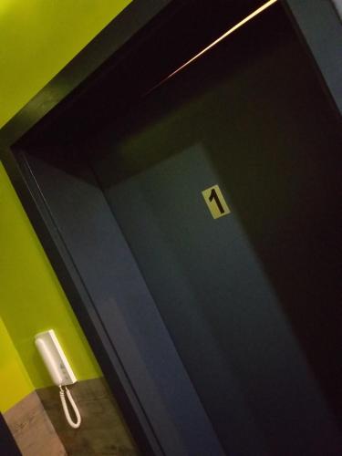 a black door with a number seven on it at modern Hoteliving Gießen in Gießen