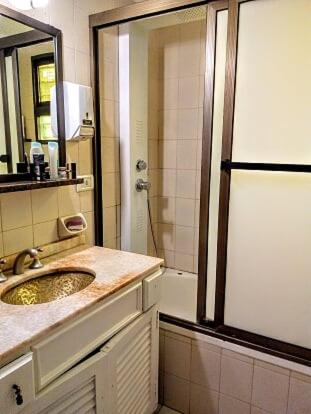 a bathroom with a sink and a shower with a mirror at Tejas Verdes Alojamiento Familiar in Villa Gesell