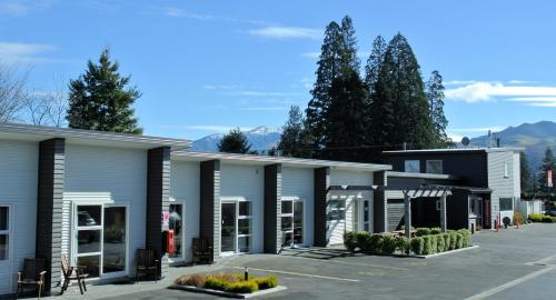 a row of buildings in a parking lot at Oxford Village Motels in Oxford