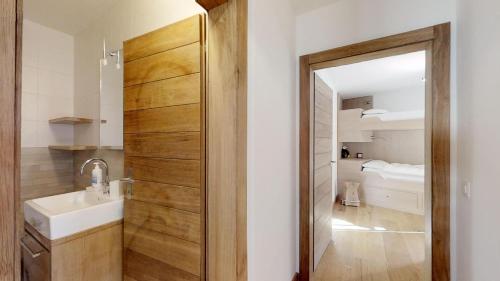 a bathroom with a sink and a mirror at Murtel 4 - Sils-Maria in Sils Maria