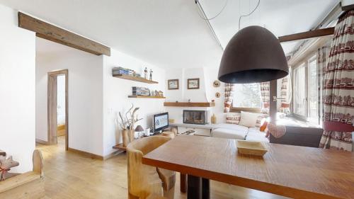 a living room with a table and a couch at Murtel 4 - Sils-Maria in Sils Maria