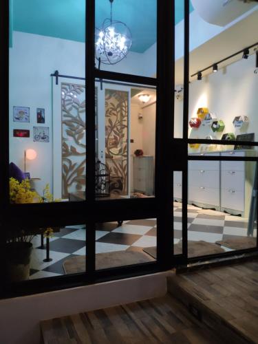 a room with a large window with a checkered floor at Teacher Cai Homeestay in Xiaoliuqiu