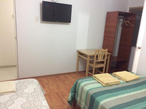 Ένα ή περισσότερα κρεβάτια σε δωμάτιο στο Hospedaje de los Reyes