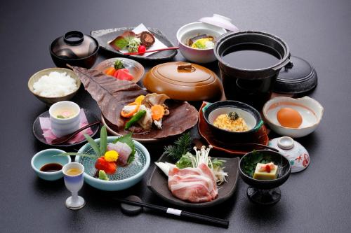 a group of dishes of food on a table at Okada Ryokan Warakutei in Takayama