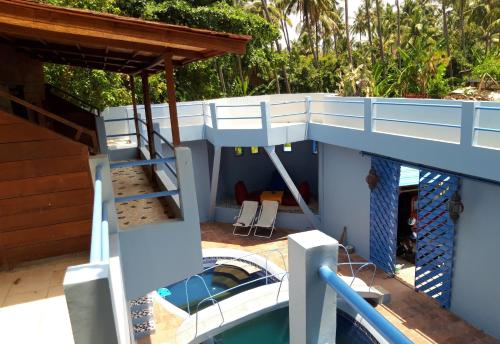 a slide on top of a house with a swimming pool at Rumah Batu in Buleleng
