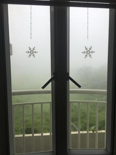 a window looking out at a foggy view at Tagaytay Prime Residence -Cityland in Tagaytay