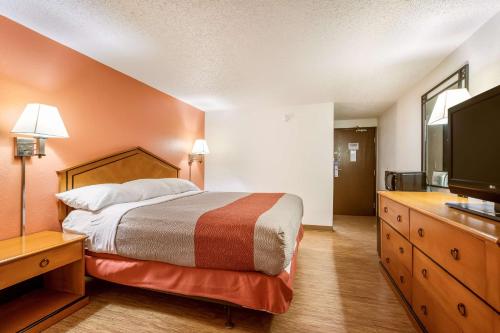 a hotel room with a bed and a flat screen tv at Motel 6-Albert Lea, MN in Albert Lea