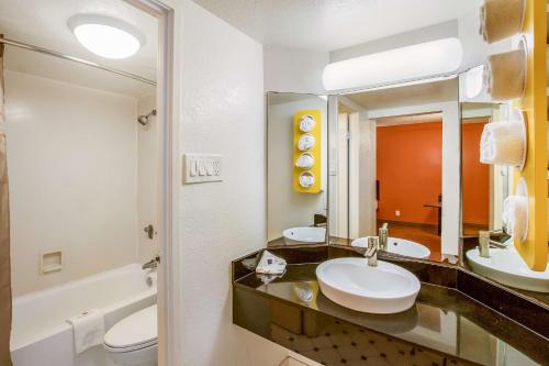 a bathroom with two sinks and a toilet and a mirror at Motel 6-Euless, TX - DFW West in Euless