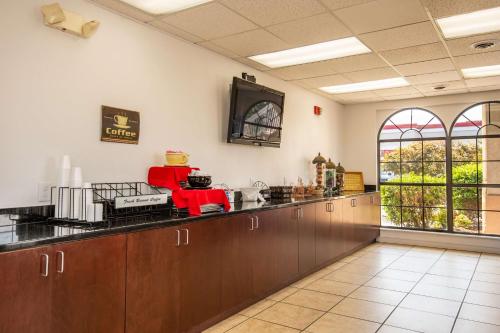 a large kitchen with wooden cabinets and a counter top at Motel 6-Kingsport, TN in Kingsport