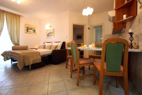 a kitchen and living room with a table and chairs at Apartments AMORE in Bol