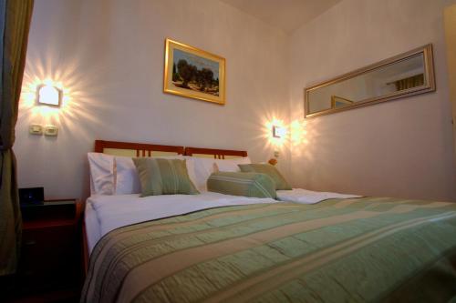 a bedroom with a bed and two lights on the wall at Apartments AMORE in Bol