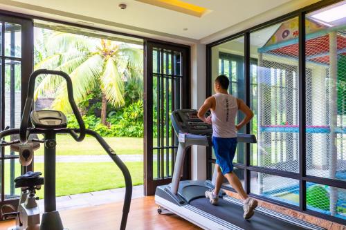 a man running on a treadmill in a gym at Narada Resort & Spa Perfume Bay Sanya - All Villas in Lingshui
