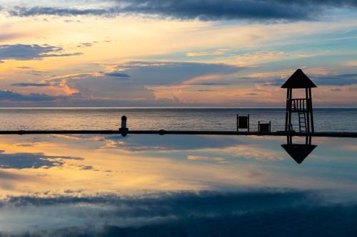 a reflection of a lifeguard tower in the water at Narada Resort & Spa Perfume Bay Sanya - All Villas in Lingshui
