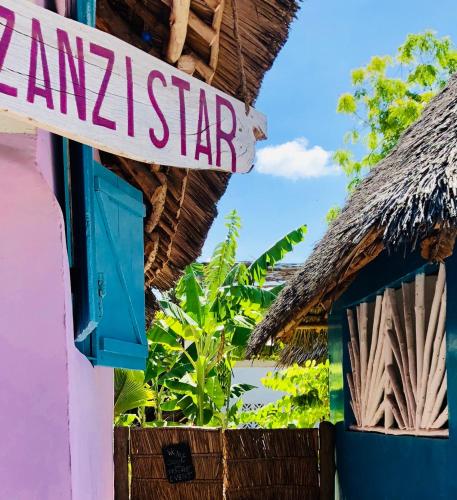 a sign for a naam star on a building at Zanzistar Lodge in Jambiani