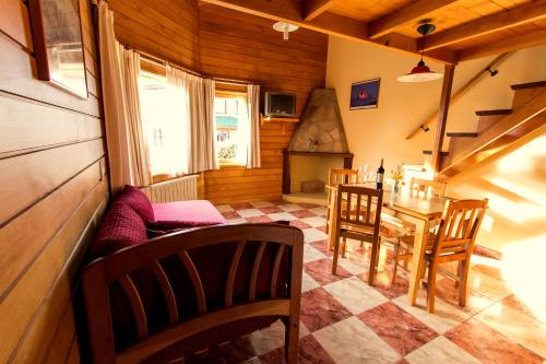 een eetkamer met een tafel en stoelen in een hut bij Linda Vista Apart Hotel in El Calafate