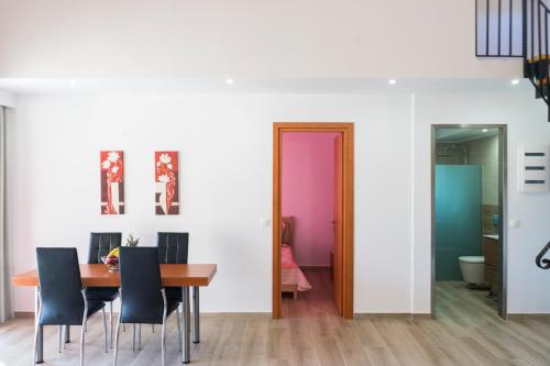 a dining room with a table and chairs at Estrella Villas in Lardos