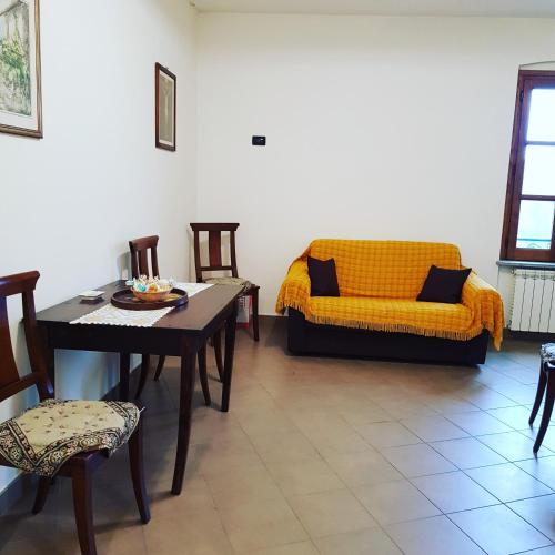 a living room with a table and a couch at La casa di Gina in Sassello