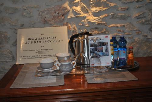 a table with a tea set and a box on it at Bed & Breakfast StudioArcodia- in San Marco dʼAlunzio