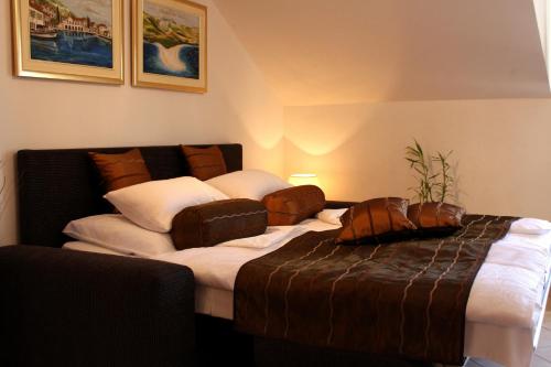 a bedroom with a large bed and a couch at Apartments AMORE in Bol