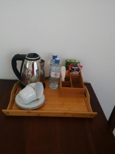 a wooden shelf with a coffee maker and a tea kettle at Airport 4 Season Transit Hotel in Katunayake